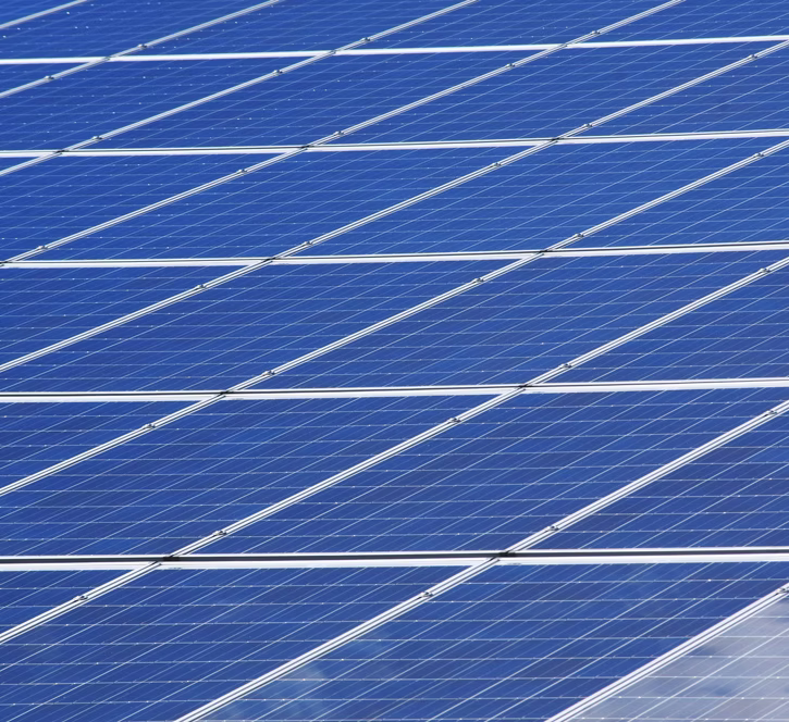 Solar panels arranged in rows, representing renewable energy and sustainable production practices