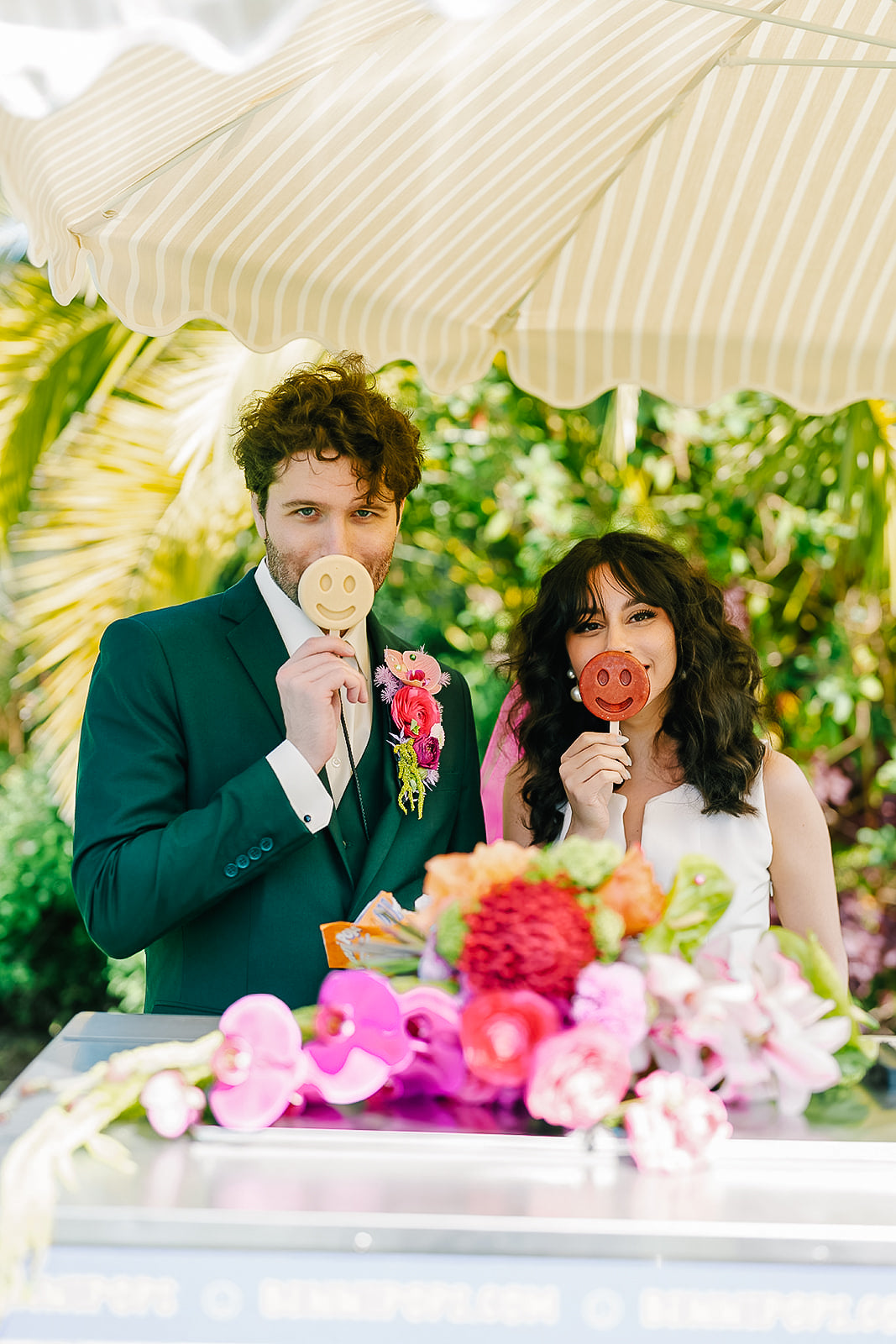 Bride and groom couple enjoying frozen desserts together at a decorated event table