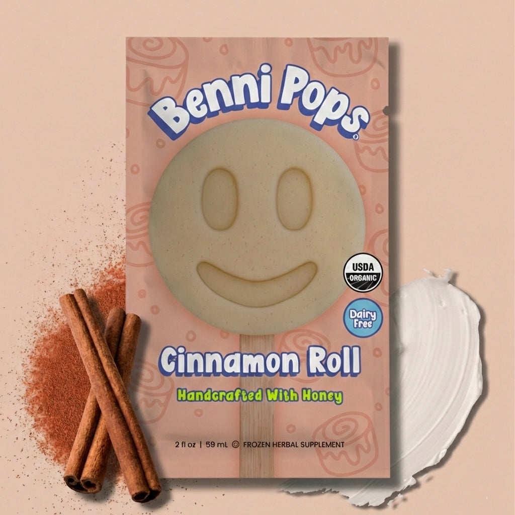 Benni Pops Cinnamon Roll frozen dessert in compostable packaging, featuring a smiley-face treat handcrafted with honey, cinnamon sticks, and a creamy dairy-free base