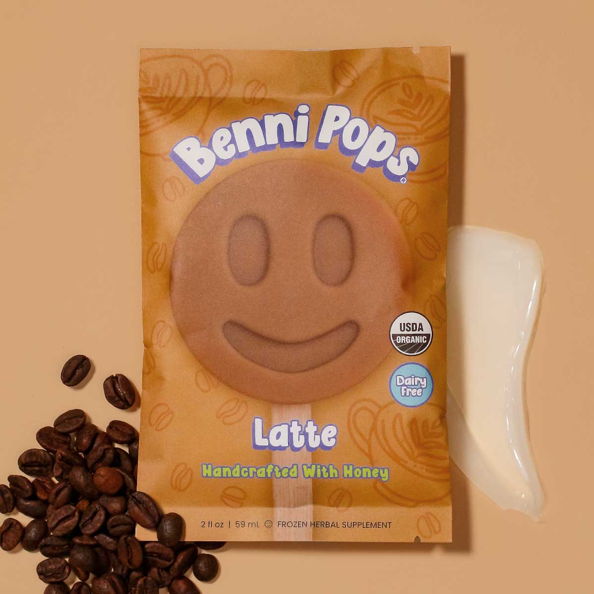 Benni Pops Latte package with coffee beans scattered beside it on a soft background