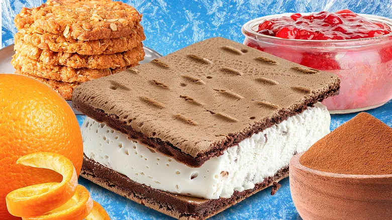 Layered frozen dessert sandwich with chocolate and cream filling, surrounded by citrus slices and textured ingredients