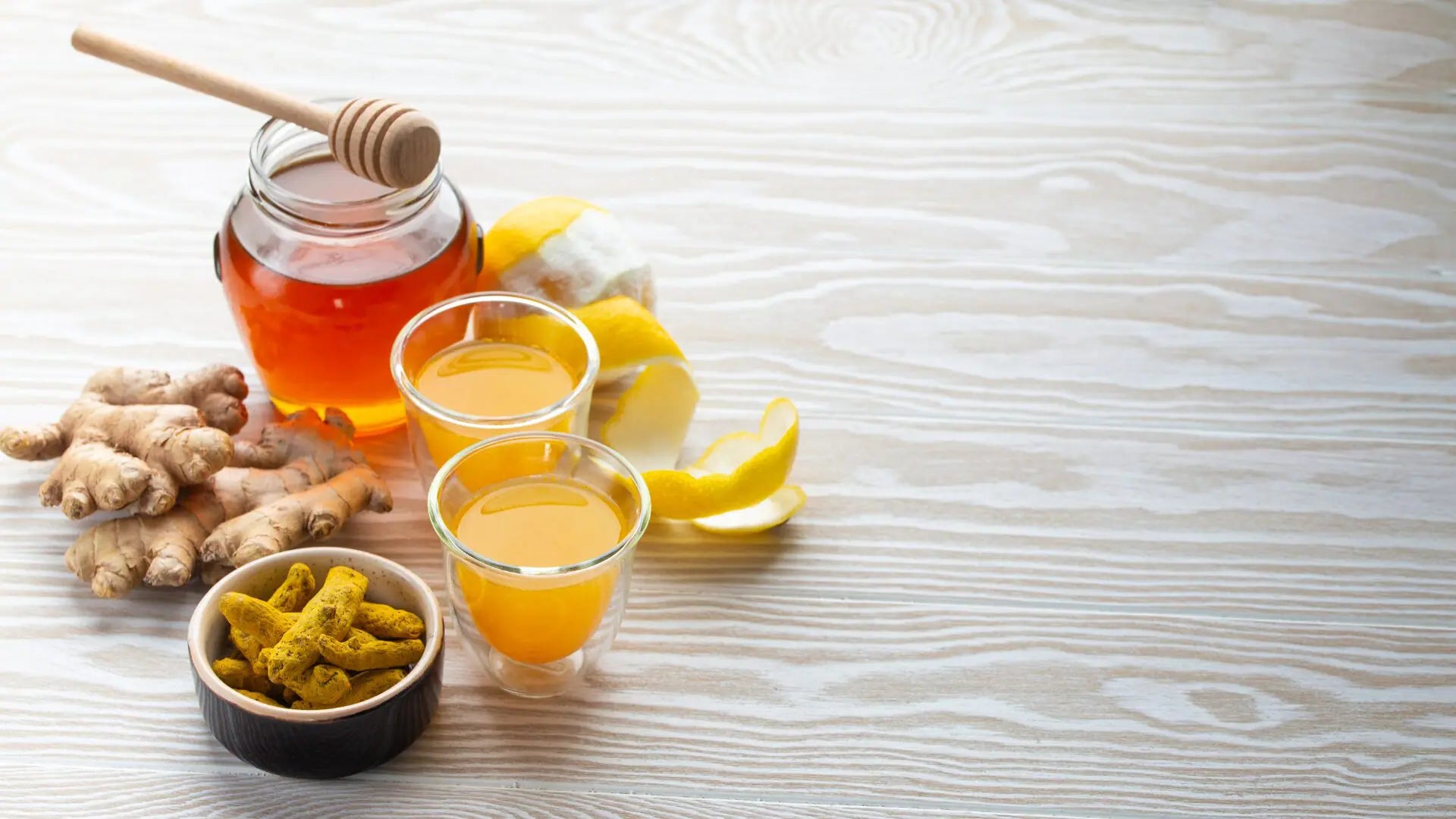 Honey, citrus juice, and fresh ingredients arranged on a wooden surface, highlighting natural sweetness and simple preparation