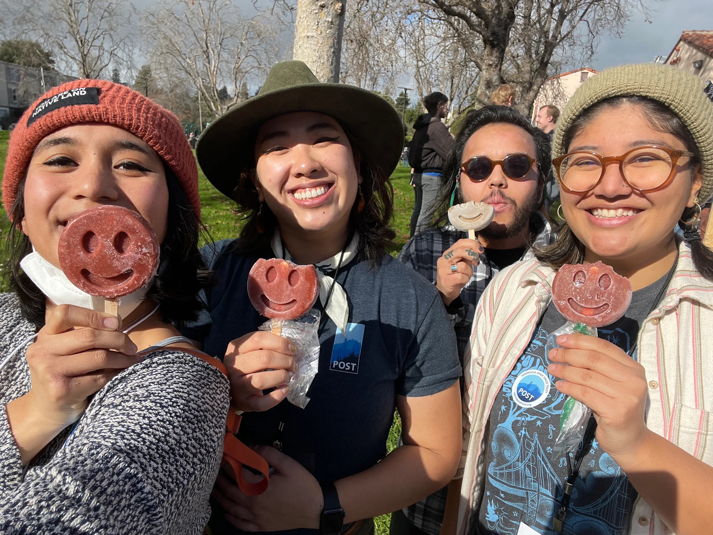 Group of people smiling and holding Benni Pops frozen desserts outdoors