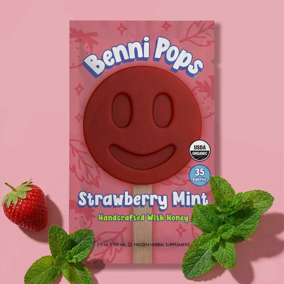 Benni Pops Strawberry Mint frozen dessert in compostable packaging, featuring a red smiley-face treat with strawberries and mint