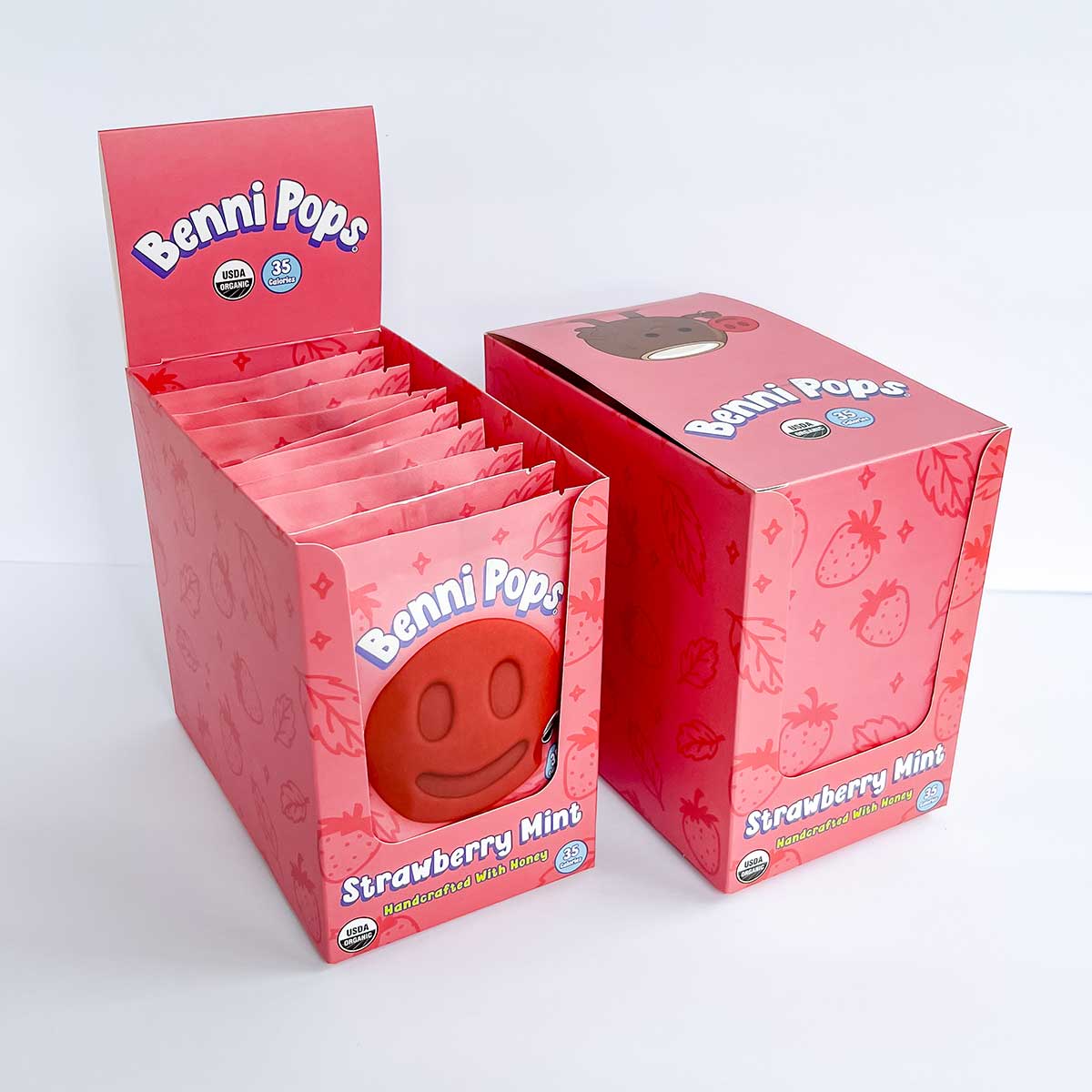Benni Pops Strawberry Mint is an organic, dairy-free fruit ice pop made with honey, strawberries and refreshing fresh mint flavor. The image features the Strawberry Mint flavor in bright branded retail display packaging with matching freezer case box.
